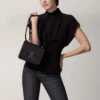 Geantă de umăr, Mini, Double C De Cartier – Piele de vițel neagră, finisaj auriu și email negru – Cartier